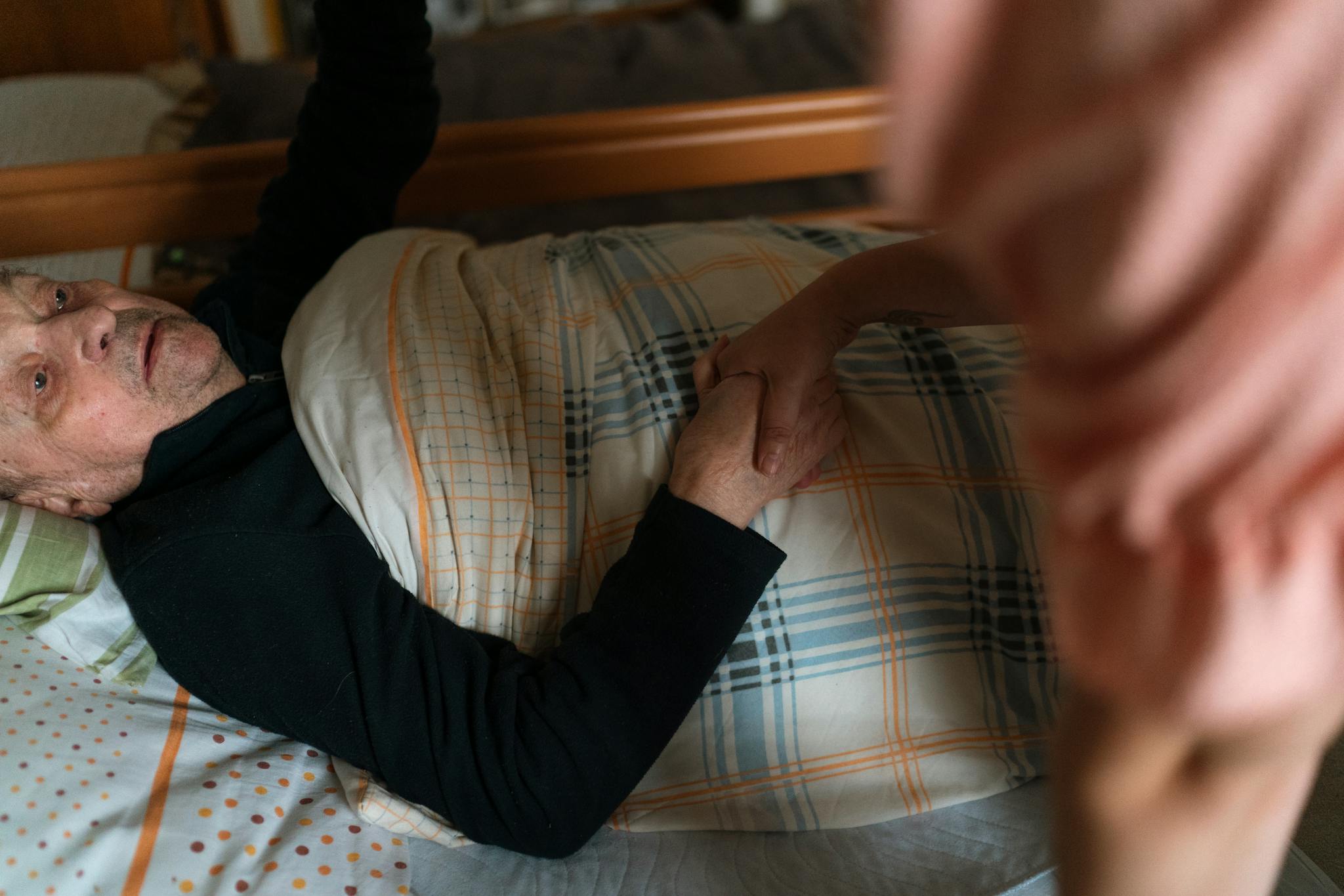 Newport companion caregiver holding hands with a senior at home — Texas companion care