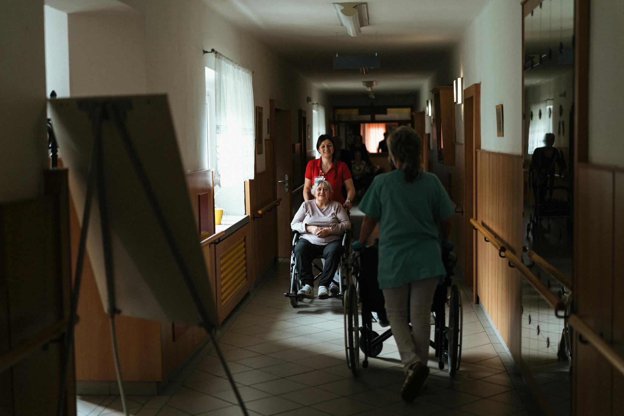 Caregiver assists elderly woman in wheelchair — Texas Medicaid STAR+PLUS home care